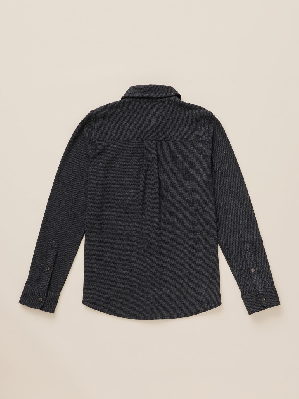 A dark charcoal gray long-sleeve button-down shirt shown from the back, laid flat on a light beige background.