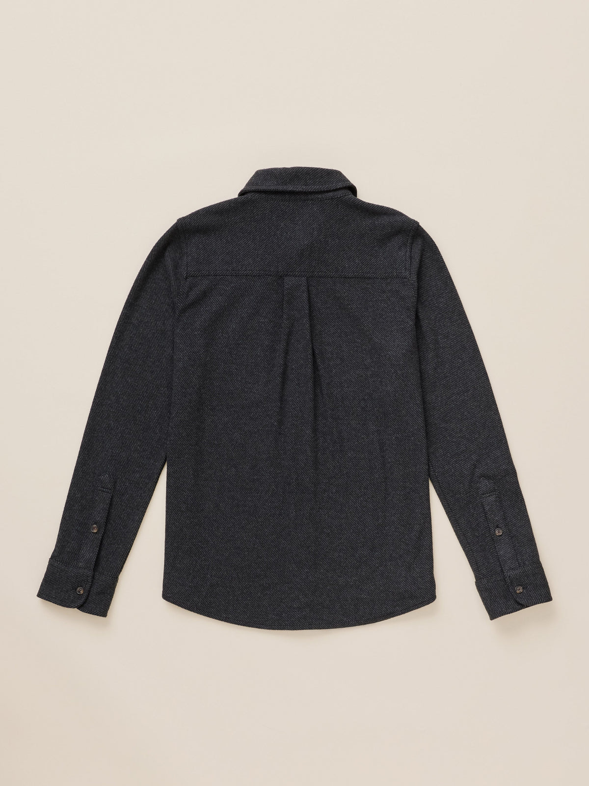 A dark charcoal gray long-sleeve button-down shirt shown from the back, laid flat on a light beige background.